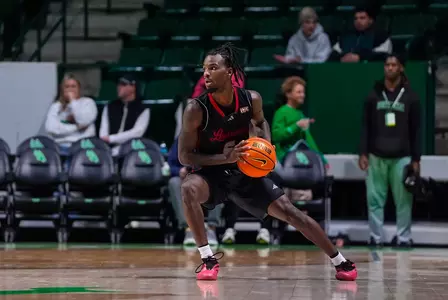 De'Vion Lavergne gets ready for work on a North Texas defender in an exhibition basketball game