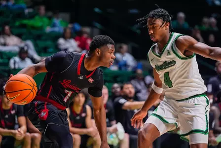 Michael Collins is guarded by a North Texas defender in an exhibition game on October 29, 2025