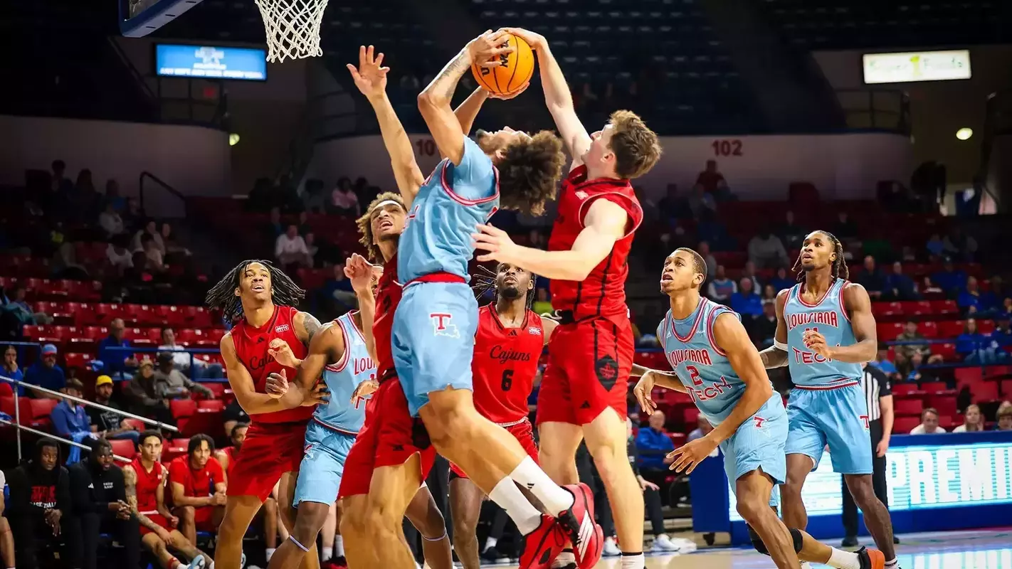 A Louisiana defender looks to block a shot by Louisiana Tech in their non-conference game on Saturday in Ruston