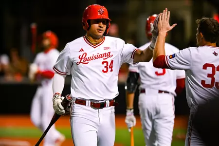 Luke Yuhasz high fives teammates February 14, 2025 Louisiana vs San Jose State Baseball Game 1 in Russo Park at M.L. "Tigue" Moore Field. Final Score Louisiana 7 SJSU 2. Photo by Benjamin R. Massey/Ragin’ Cajun Athletics
