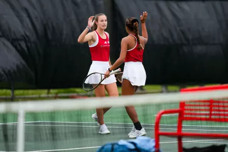 Angelique Berrat and Jenaila Prulla high fives February 18, 2025 Louisiana vs. McNeese Women’s Tennis at Cajun Courts in Lafayette, LA. Final score POSTPONED. Photo by Benjamin R. Massey/Ragin’ Cajuns Athletics