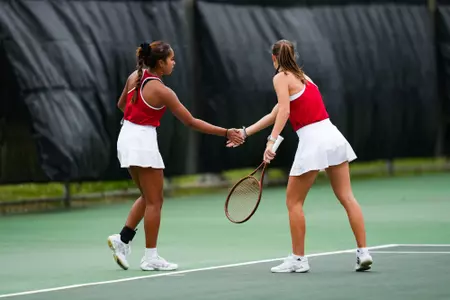 Jenaila Prulla and Angelique Berrat high five February 18, 2025 Louisiana vs. McNeese Women’s Tennis at Cajun Courts in Lafayette, LA. Final score POSTPONED. Photo by Benjamin R. Massey/Ragin’ Cajuns Athletics