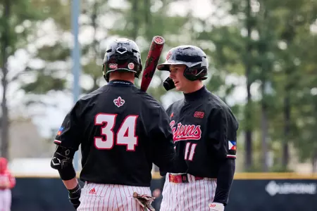 Brooks Wright and Luke Yuhasz talk February 22, 2025 Louisiana vs Nebraska Game 2 Baseball in Russo Park at M.L. "Tigue" Moore Field. Final Score Louisiana 4 Nebraska 1. Photo by JC Orillion/Ragin’ Cajuns Athletics