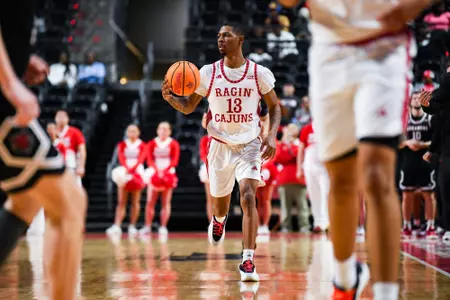 Christian Wright dribbles February 26, 2025 Louisiana vs Arkansas State Men's Basketball in Lafayette, LA at the Cajundome. Final score Louisiana 64 ASU 83. Photo by Benjamin R. Massey/Ragin’ Cajuns Athletics