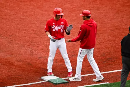 Caleb Stelly and Trey LaFleur high five March 9, 2025 Louisiana vs Dallas Baptist Game 3 Baseball in Russo Park at M.L. "Tigue" Moore Field. Final Score Louisiana 2 DBU 8. Photo by Benjamin R. Massey/Ragin’ Cajuns Athletics