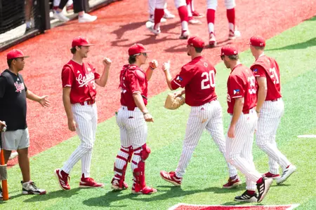 Teammates high five JR Tollett after an inning March 30, 2025 Louisiana vs James Madison University Baseball Game 3 in Russo Park at M.L. "Tigue" Moore Field. Final Score Louisiana 3 JMU 0. Photo by Mikey White/Ragin’ Cajuns Athletics