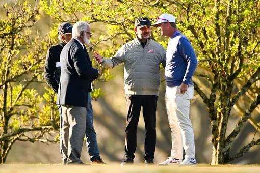 Theo Sliman talking with a golf coach (right) and his father, Teddy Sliman (left) during the 2025 Louisiana Classics at Oakbourne Country Club