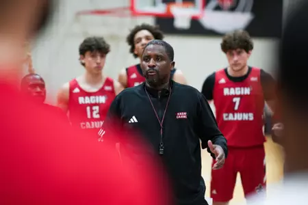 Quannas White addresses the team during practice