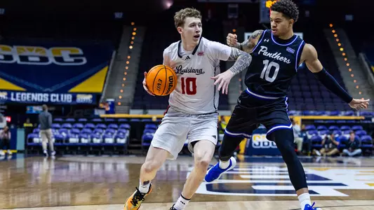 Louisiana's Jaxon Olvera drives past Georgia State's Jelani Hamilton on Tuesday in the 2026 Visit Pensacola Sun Belt Conference Men's Basketball Championships