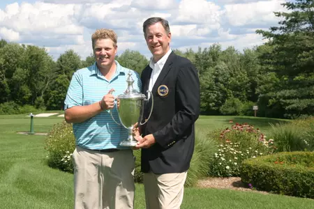 Pat Wilson and Jeff Holzschuh hold the Met Amateur Championship trophy on Sunday afternoon.