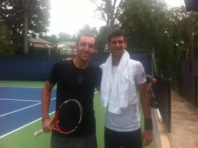 Former St. John's men's tennis player Vasko Mladneov poses with world No. 1 Novak Djokovic after a workout at the U.S. Open.