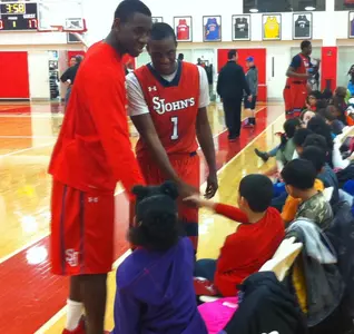 Juniors Phil Greene IV and Sir'Dominic Pointer talk to kids from P.S. 198's