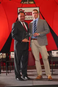 Kieran McArdle accepts the Frank C. Haggerty Memorial Award from St. John's Director of Athletics Chris Monasch at the 68th Annual Athletic Awards Celebration.