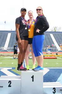 Senior Danette Hinton, left, stands on the BIG EAST Championship podium following her runner-up finish in the hammer throw.