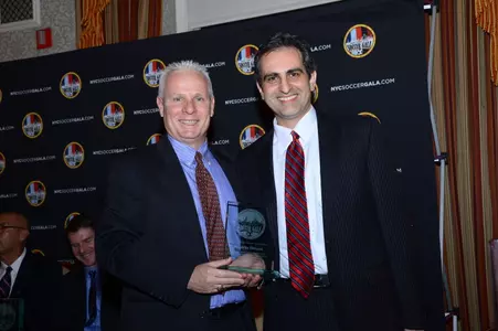 St. John's head coach Dr. Dave Masur and University honoree Roberto DeLuca.