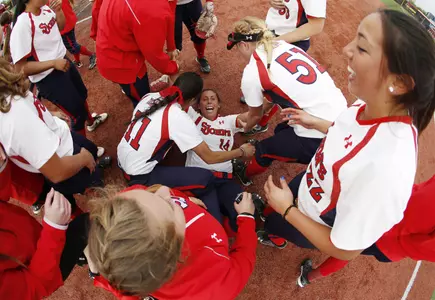 Senior Francesca Carrullo gets tackled by her teammates after picking up the final strikeout of the game to end the 2015 BIG EAST Championship and seal the first ever title for St. John's. (Photo courtesy of BIG EAST/Steve Woltmann)