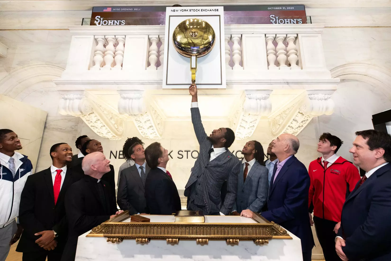 Drissa Traore of the St. John's men's basketball team rings The Opening Bell at the New York Stock Exchange