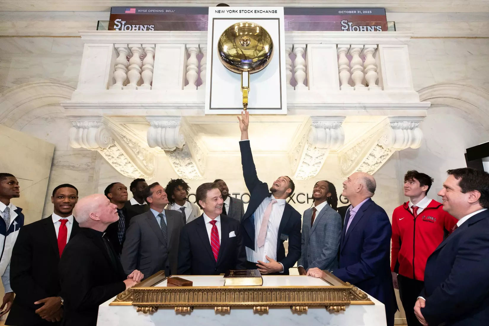 Chris Ledlum of the St. John's men's basketball team rings The Opening Bell at the New York Stock Exchange