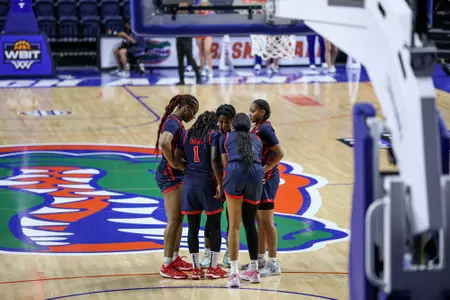 The team huddles during a stoppage in play.