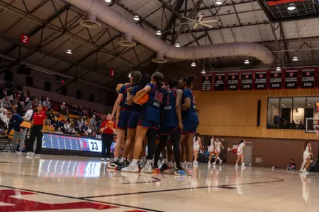 The St. John's women's basketball team huddles up during a timeout.