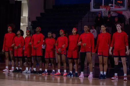 The team stands for the National Anthem before the game.