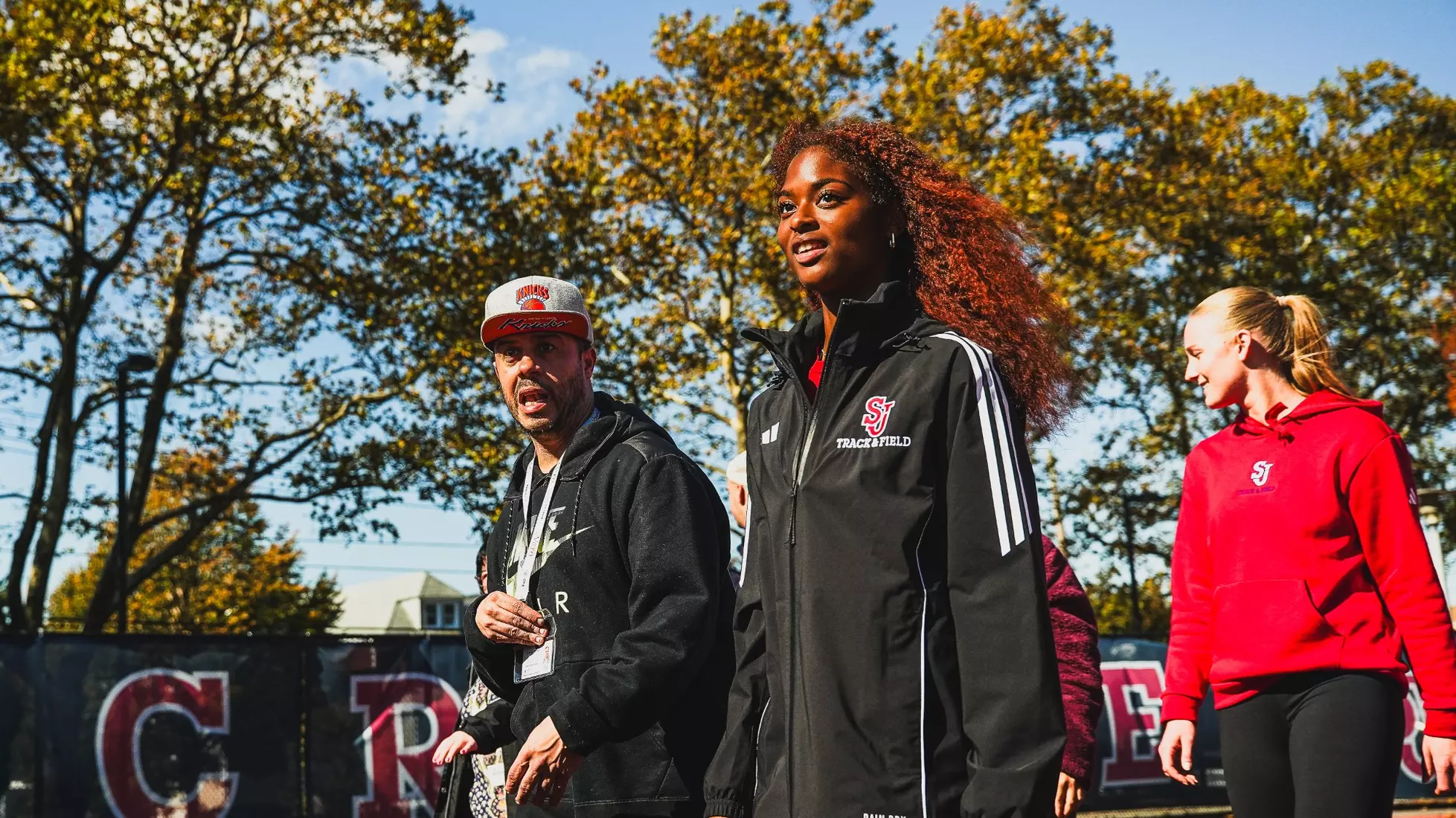 Members of QCP and SJUTF walking the track at the DaSilva Athletic Complex.