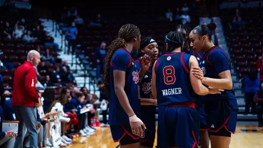The Red Storm huddles up near the sideline.