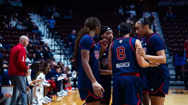 The Red Storm huddles up near the sideline.
