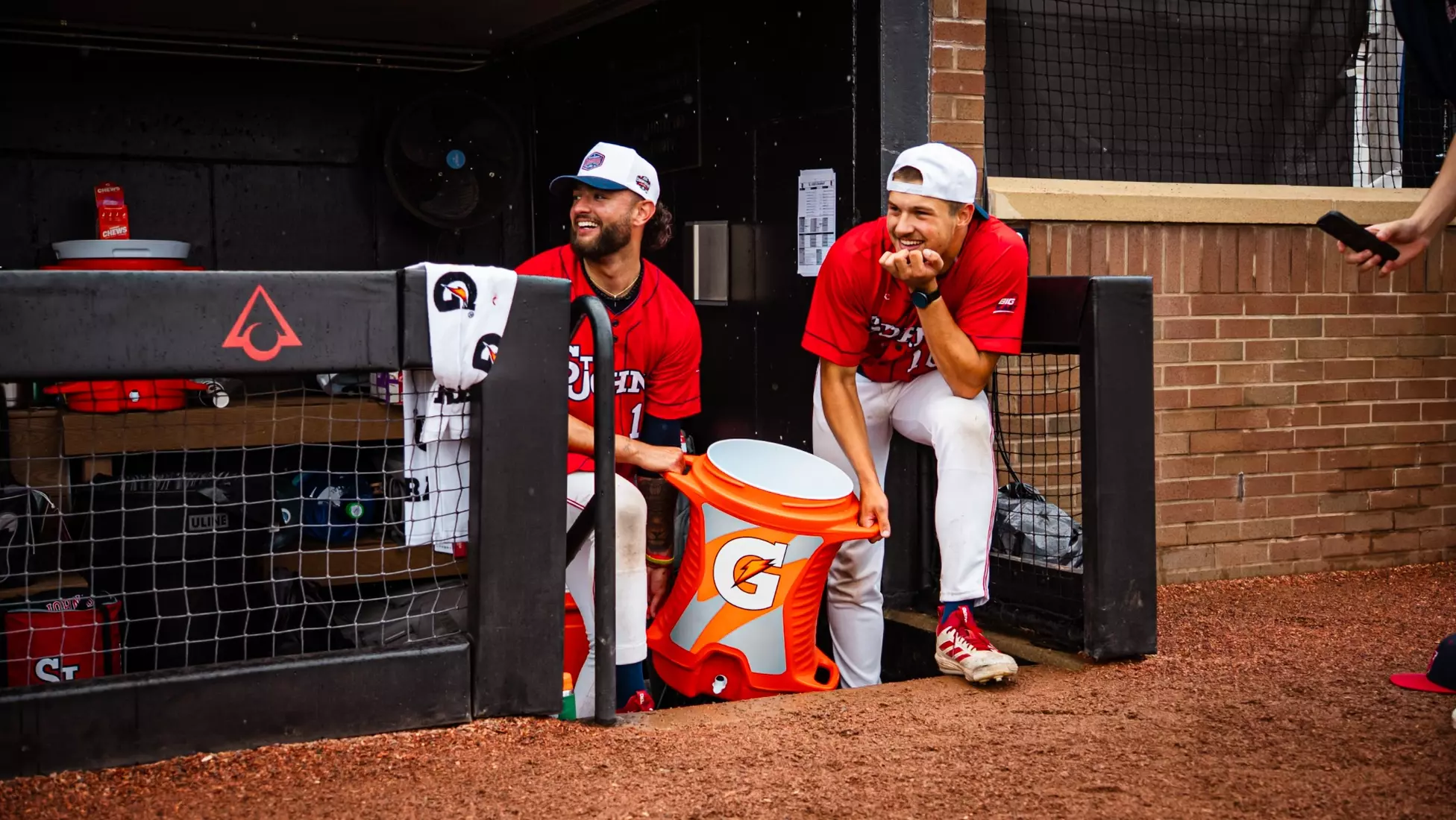 Dylan Johnson and Brady Clark ready with Gatorade to dump on coach post-win