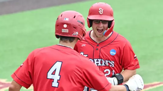 Rob Mansour and Cristian Bernardini celebrate Dylan Fitzsimmons three run homer