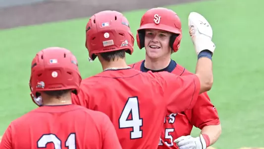 Dylan Fitzsimmons, Rob Mansour and Cristian Bernardini celebrate Fitzsimmons three run homer
