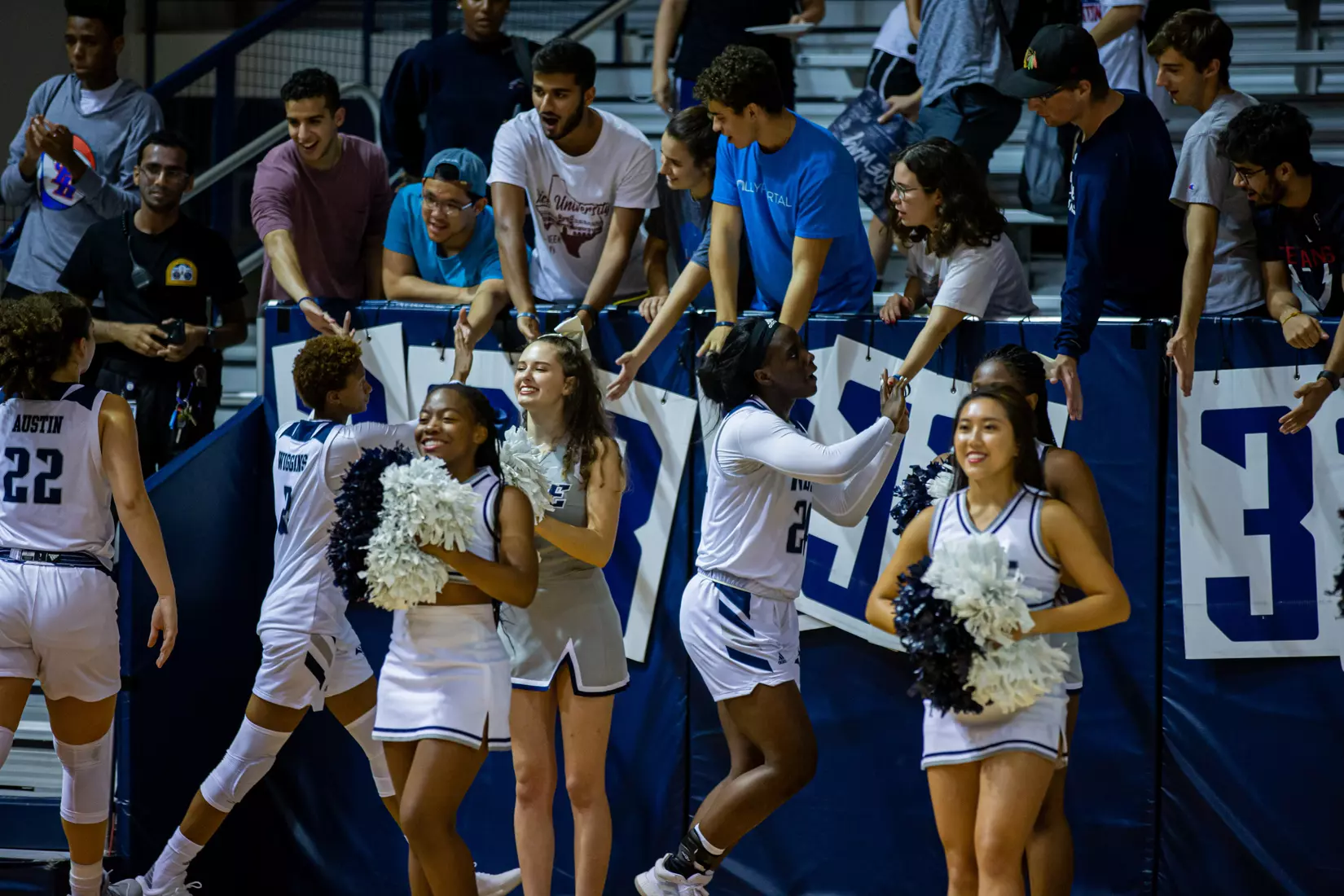 Owls high five student section after the win.