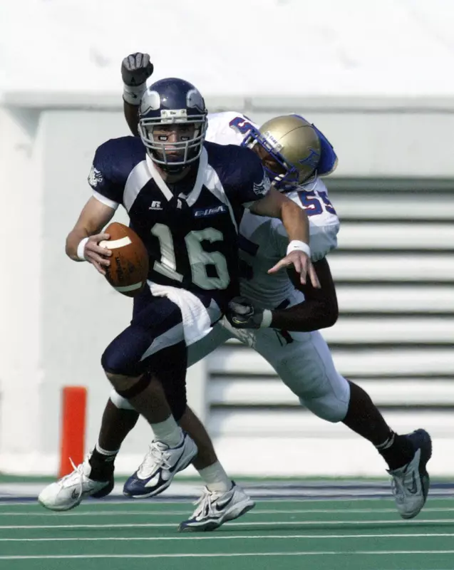 Rice quarterback Chase Clement tries to escape Tulsa's Nelson Coleman after coming in off the bench during the second quarter. (AP Photo/Jessica Kourkounis)