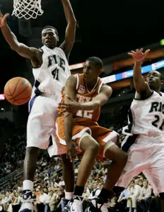 Patrick Britton defends as Texas' Kenton Paulino attempts to pass. (AP Photo)