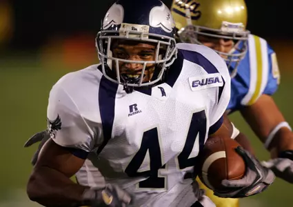 Rice's Quinton Smith breaks a tackle by UCLA's Jarrad Page during the first half. (AP Photo/Mark J. Terrill)
