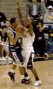 Lorenzo Williams is defended by Southern Mississippi guard Travis Hall as he looks for an open player during the first half. (AP Photo/Steve Coleman)