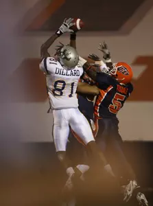 Rice receiver Jarett Dillard, left, leaps over Texas-El Paso defenders Quintin Demps and Bryant Tisdale, right, to grab a first-quarter, 34-yard touchdown pass.