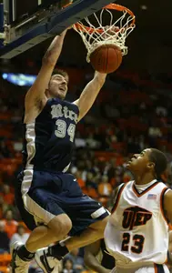 Rice's Scott Saunders slam dunks over UTEP's Gabriel McCulley during the first half. (AP Photo/El Paso Times, Victor Calzada)