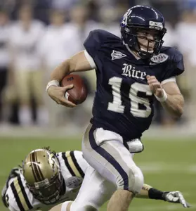 Chase Clement rushes for a touchdown as Louis Delmas tries to tackle him during the first quarter.