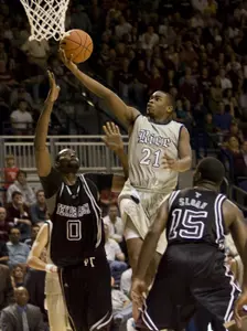 Rodney Foster shoots the ball over Texas A&M's Bryan Davis, left, and Donald Slaon during the second half.(AP Photo/Houston Chronicle, James Nielsen)