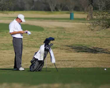 Michael Buttacavoli looks over his yardage book before attempting a shot on the fourth hole of Westwood Golf Club Tuesday.