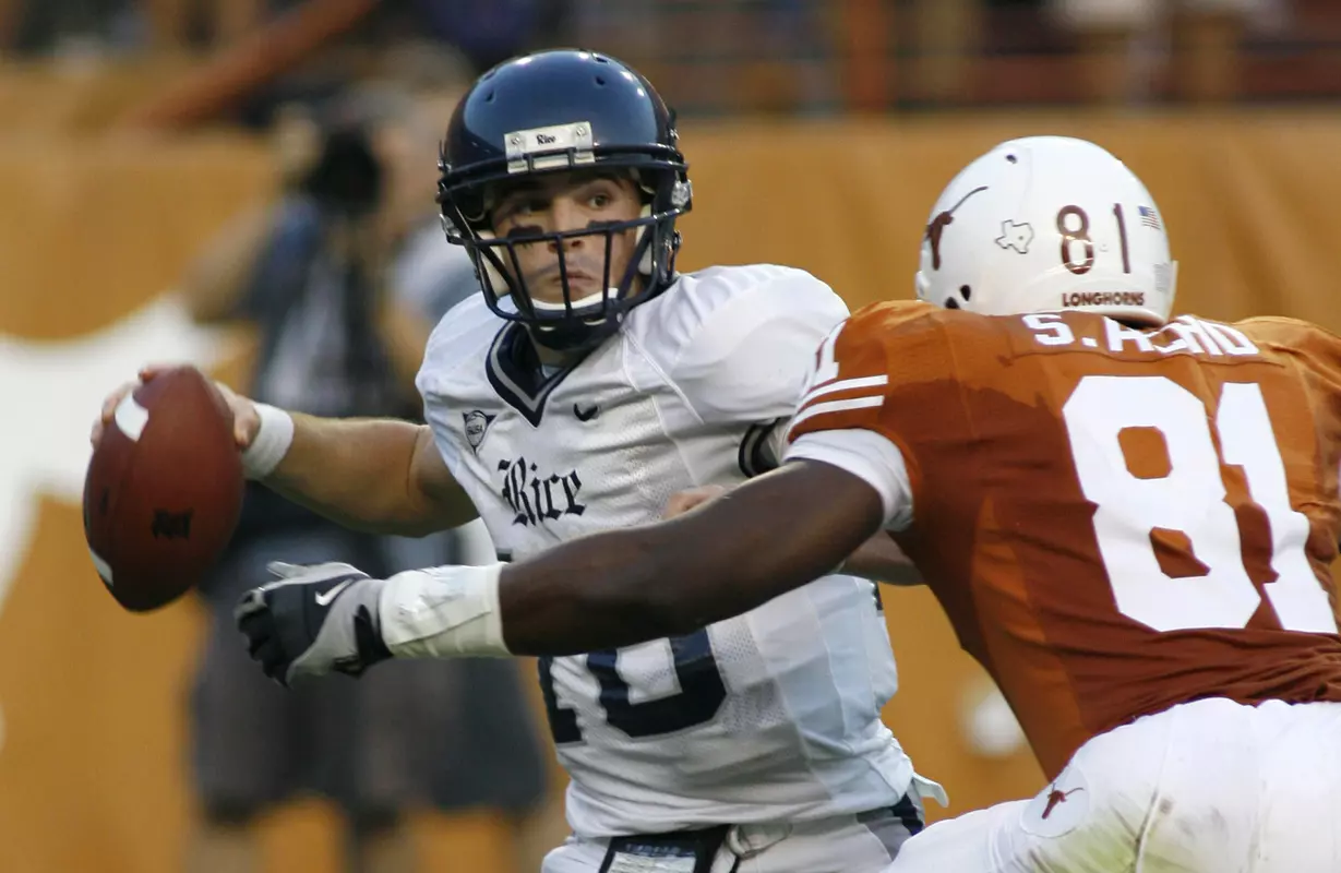 Chase Clement is pressured by the pass rush of Texas defensive end Sam Acho during the second quarter. (AP Photo)