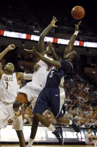 Tamir Jackson, right, goes up for a shot against Texas defenders Jordan Hamilton, center, and Gary Johnson (1). (AP Photo/Erich Schlegel)