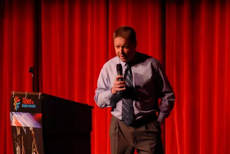 Rice basketball coach addresses students at Pershing Middle School about the benefits of reading as the school tipped off the Ticket To Reading Rewards program sponsored by the National Association of Basketball Coaches.