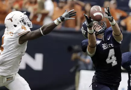 Rice wide receiver Randy Kitchens, right, reaches for the ball. (AP)