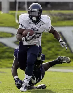 Rice running back Tyler Smith, who had 84 yards on a season-high 21 carries, runs past Northwestern linebacker Damien Proby in the first half.