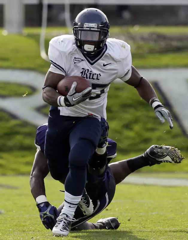 Rice running back Tyler Smith, who had 84 yards on a season-high 21 carries, runs past Northwestern linebacker Damien Proby in the first half.