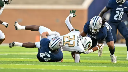 October 01, 2022: Rice Owls linebacker Treshawn Chamberlain (8) and linebacker Aidan Siano (44) tackle UAB Blazers running back DeWayne McBride (22) during the first quarter at Rice Stadium in Houston, Texas. (Mandatory Credit: Maria Lysaker | Rice Athletics)