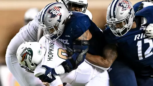 October 01, 2022: Rice Owls linebacker Josh Pearcy (12) and Rice Owls defensive end Trey Schuman (7) sack UAB Blazers quarterback Dylan Hopkins (9) during fourth quarter at Rice Stadium in Houston, Texas. Mandatory Credit: Maria Lysaker | Rice Athletics