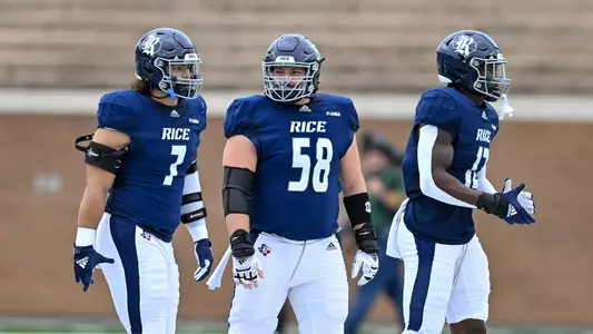 October 29, 2022: Rice Owls captains offensive lineman Shea Baker (58), defensive end Trey Schuman (7) and linebacker Josh Pearcy (12) look on during the coin toss to start the game against the Charlotte 49ers at Rice Stadium in Houston, Texas. Mandatory Credit: Maria Lysaker | Rice Athletics